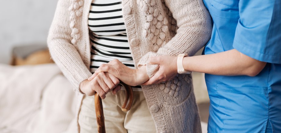 Gentle trained nurse helping mature patient