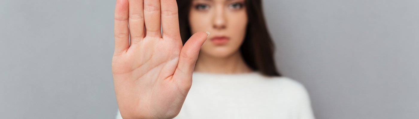 Close up portrait of a woman showing stop gesture